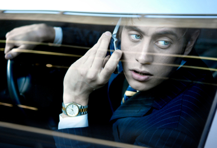 Businessman on cell phone in car